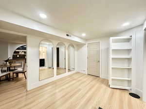 Interior space featuring built in features and light hardwood / wood-style flooring