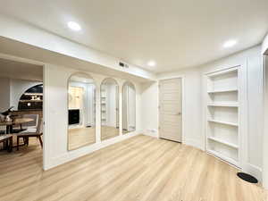 Interior space featuring built in features and light hardwood / wood-style floors