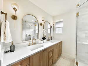 Bathroom featuring vanity, tile patterned floors, and a shower with shower door