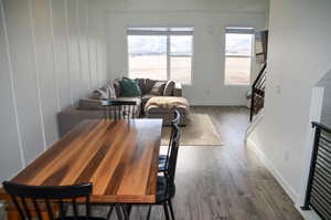 Dining area with dark hardwood / wood-style floors