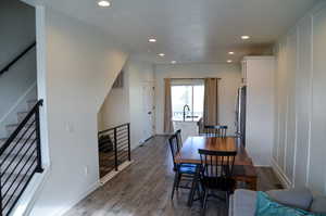 Dining room with dark hardwood / wood-style flooring and sink