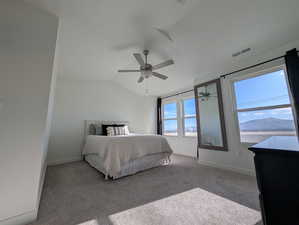 Master Bedroom with a mountain view, vaulted ceiling, multiple windows, and ceiling fan