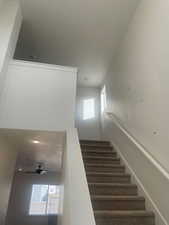 Staircase featuring ceiling fan