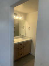 Bathroom with a textured ceiling and vanity