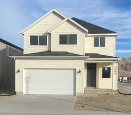 View of property with a garage