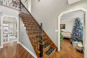 Stairs with ornamental molding and hardwood / wood-style flooring