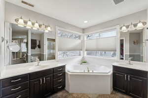 Bathroom with vanity and separate shower and tub