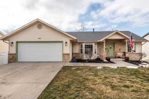 Ranch-style home featuring a garage and a front yard