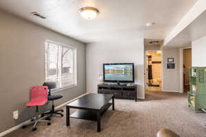 Carpeted living room featuring a textured ceiling