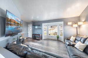 Living room featuring dark hardwood / wood-style flooring and vaulted ceiling