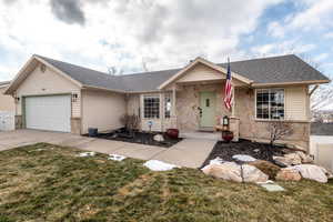 Ranch-style house featuring a front lawn and a garage