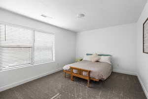 Carpeted bedroom featuring a textured ceiling