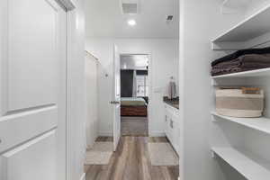 Bathroom with vanity, curtained shower, and wood-type flooring