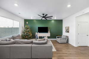 Living room featuring ceiling fan and wood-type flooring