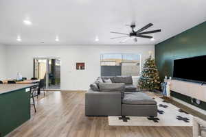 Living room featuring hardwood / wood-style flooring and ceiling fan