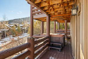 Snow covered deck with a hot tub