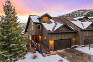 View of front of house featuring a mountain view and a garage