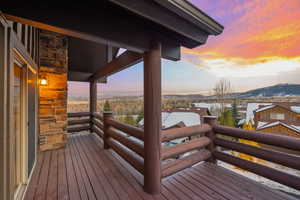 Snow covered deck with a mountain view