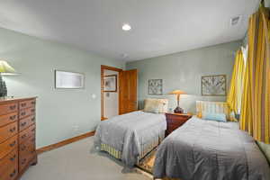 Bedroom featuring light colored carpet