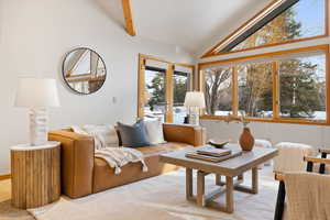 Sunroom with vaulted ceiling with beams