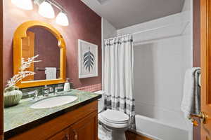 Full bathroom featuring shower / bath combo, toilet, and vanity