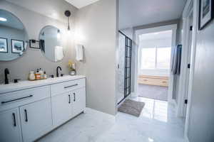 Bathroom with vanity and a shower with shower door