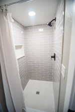 Bathroom featuring curtained shower