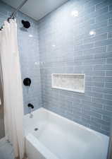 Bathroom with shower / tub combo with curtain