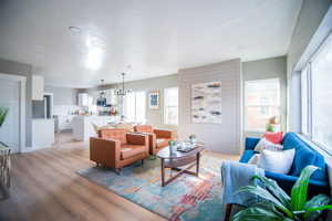 Living room with a notable chandelier and light wood-type flooring