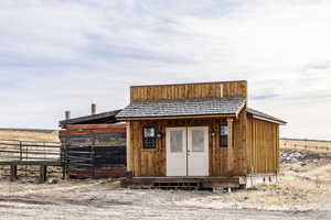 View of outbuilding featuring a rural view