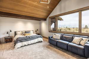 Carpeted bedroom featuring wood ceiling and vaulted ceiling