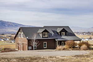 View of front facade with a mountain view and a garage