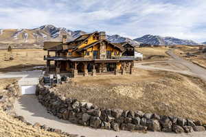 Exterior space with a mountain view, a porch, and a garage