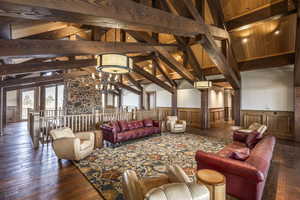 Interior space featuring beam ceiling, high vaulted ceiling, and dark wood-type flooring