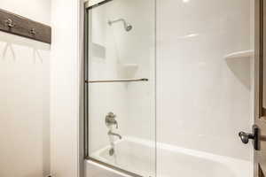 Bathroom with enclosed tub / shower combo