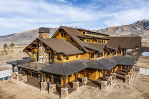 Rear view of house with a mountain view and a balcony