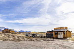 Exterior space with a mountain view, a rural view, and an outbuilding