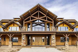 Log home featuring a balcony