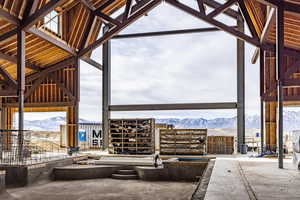 Snow covered patio with a mountain view