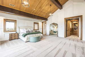 Carpeted bedroom featuring wooden ceiling and vaulted ceiling