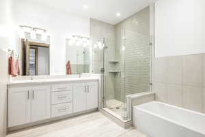 Bathroom with vanity and separate shower and tub