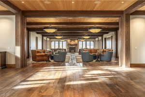 Unfurnished living room featuring beam ceiling and hardwood / wood-style flooring