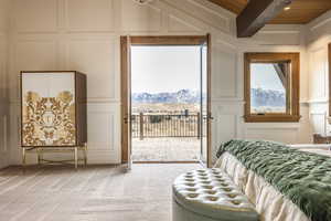 Carpeted bedroom featuring a mountain view, beam ceiling, access to outside, and wooden ceiling