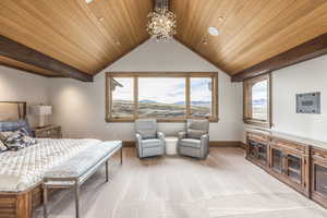 Carpeted bedroom featuring lofted ceiling, multiple windows, and wooden ceiling