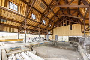 Misc room with beamed ceiling, high vaulted ceiling, and a wealth of natural light