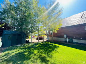 View of yard featuring a storage unit