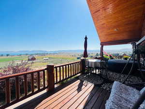 Deck with a mountain view and a rural view