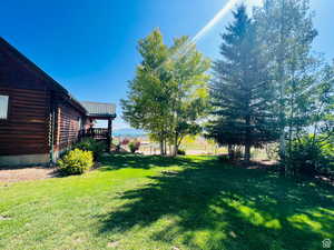 View of yard with a wooden deck