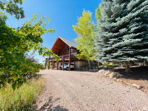 View of front of property featuring a wooden deck