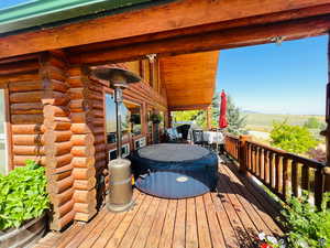 Wooden deck featuring a hot tub